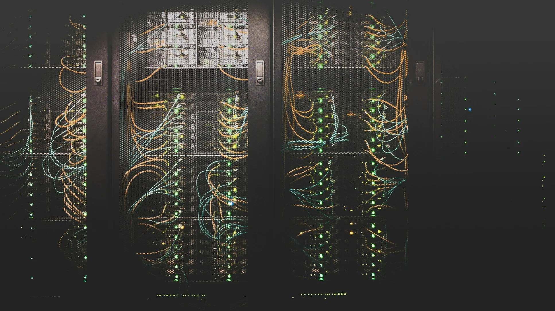 Computer servers in a rack connected by cables.